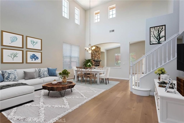 3450 Lake Park Ave, Fallbrook, CA 92028 - living area with light wood finished floors, arched walkways, a high ceiling, stairs, and a chandelier