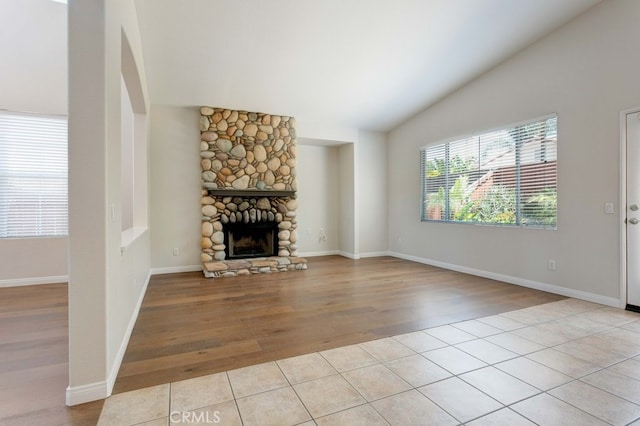 3450 Lake Park Ave, Fallbrook, CA 92028 - unfurnished living room featuring light wood-style flooring, a stone fireplace, vaulted ceiling, and arched walkways