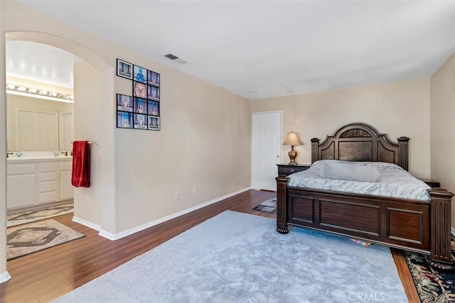 3450 Lake Park Ave, Fallbrook, CA 92028 - bedroom featuring wood finished floors, arched walkways, and ensuite bath