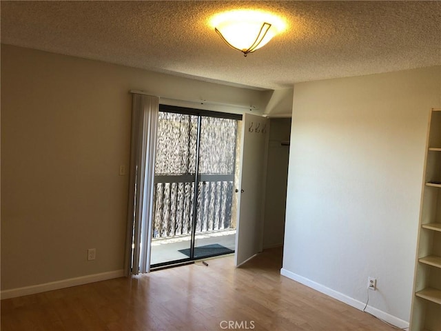 1112 S Meyler St Unit 8, San Pedro, CA 90731 - spare room with wood finished floors and a textured ceiling