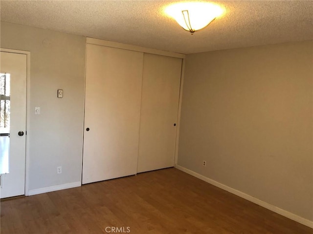 1112 S Meyler St Unit 8, San Pedro, CA 90731 - unfurnished bedroom featuring wood finished floors, a closet, and a textured ceiling
