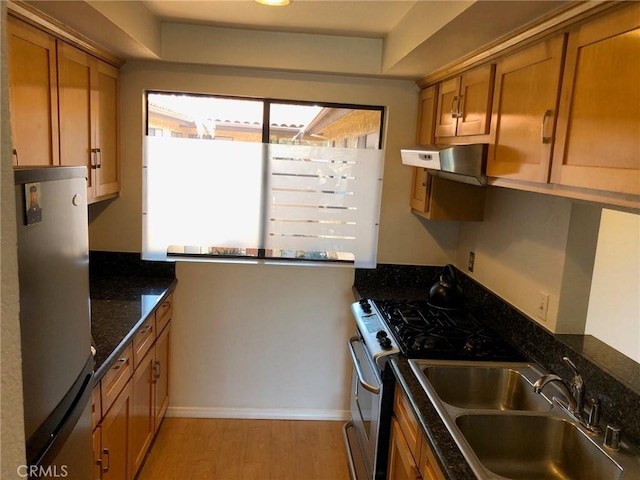1112 S Meyler St Unit 8, San Pedro, CA 90731 - kitchen featuring appliances with stainless steel finishes, wall chimney range hood, brown cabinets, light wood finished floors, and a raised ceiling