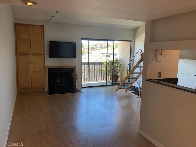 1112 S Meyler St Unit 8, San Pedro, CA 90731 - unfurnished living room featuring wood finished floors and a fireplace