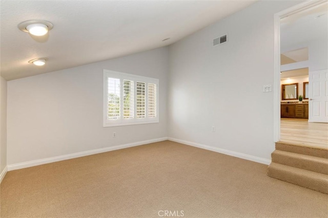 23609 Wilmington Ct, Valencia, CA 91354 - spare room featuring lofted ceiling and light carpet