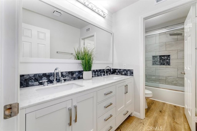 23609 Wilmington Ct, Valencia, CA 91354 - full bath featuring double vanity, wood finished floors, and bath / shower combo with glass door