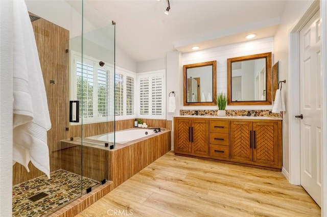 23609 Wilmington Ct, Valencia, CA 91354 - full bathroom featuring a garden tub, double vanity, a shower stall, and wood finished floors