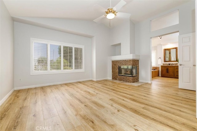 23609 Wilmington Ct, Valencia, CA 91354 - unfurnished living room with light wood finished floors, lofted ceiling, a ceiling fan, and a high end fireplace