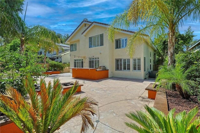 23609 Wilmington Ct, Valencia, CA 91354 - back of property featuring stucco siding and a patio