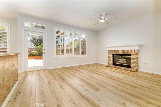 23609 Wilmington Ct, Valencia, CA 91354 - unfurnished living room featuring a fireplace, wood finished floors, plenty of natural light, and a ceiling fan