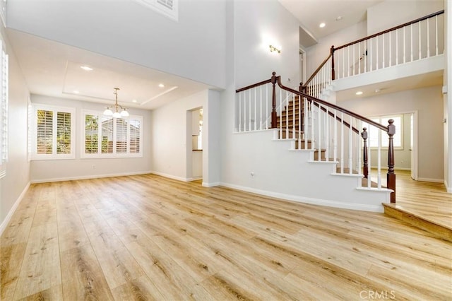 23609 Wilmington Ct, Valencia, CA 91354 - unfurnished living room featuring a chandelier, hardwood / wood-style floors, plenty of natural light, stairs, and recessed lighting