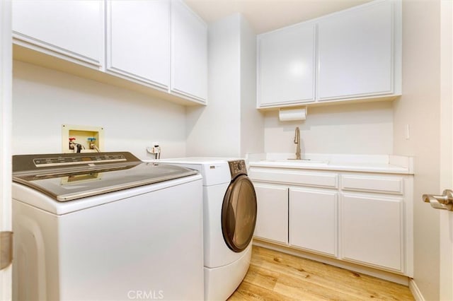 23609 Wilmington Ct, Valencia, CA 91354 - laundry area featuring washer and dryer, cabinet space, and light wood-type flooring
