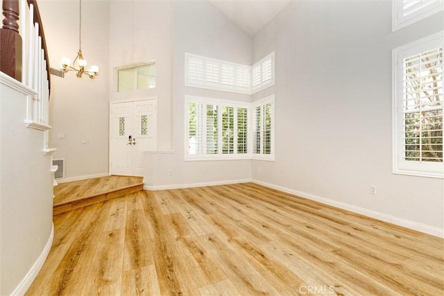 23609 Wilmington Ct, Valencia, CA 91354 - entryway with a chandelier, high vaulted ceiling, and wood finished floors