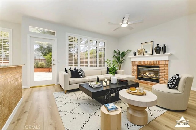 23609 Wilmington Ct, Valencia, CA 91354 - living room with a brick fireplace, wood finished floors, a ceiling fan, and plenty of natural light