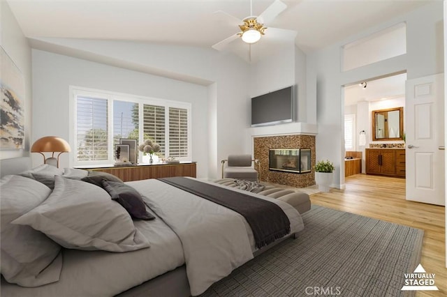 23609 Wilmington Ct, Valencia, CA 91354 - bedroom featuring light wood-type flooring, lofted ceiling, a fireplace, connected bathroom, and ceiling fan