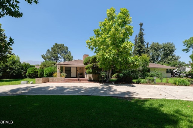 3505 E California Blvd, Pasadena, CA 91107 - view of front of house featuring a front yard, a chimney, and stucco siding