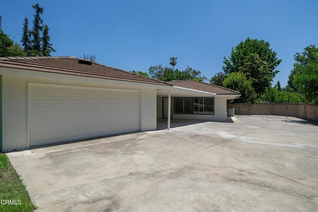 3505 E California Blvd, Pasadena, CA 91107 - view of front of house featuring driveway, a tiled roof, stucco siding, and a garage