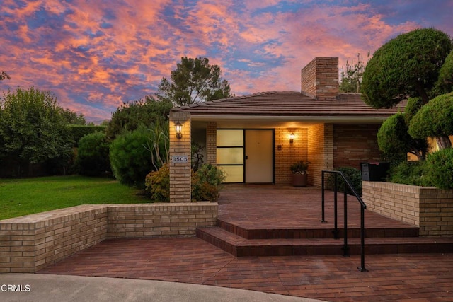 3505 E California Blvd, Pasadena, CA 91107 - view of front of property with a chimney, a front yard, and brick siding