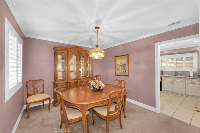 12111 Reagan St, Los Alamitos, CA 90720 - dining room with a chandelier, light carpet, and crown molding