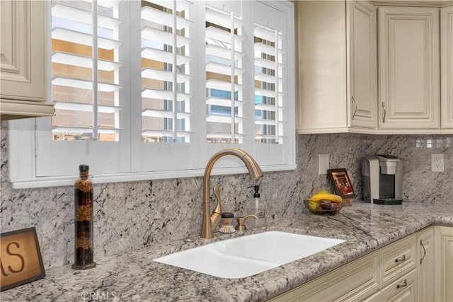 12111 Reagan St, Los Alamitos, CA 90720 - kitchen with decorative backsplash, cream cabinetry, and light stone counters