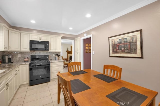 12111 Reagan St, Los Alamitos, CA 90720 - kitchen featuring black appliances, decorative backsplash, light tile patterned floors, crown molding, and white cabinets