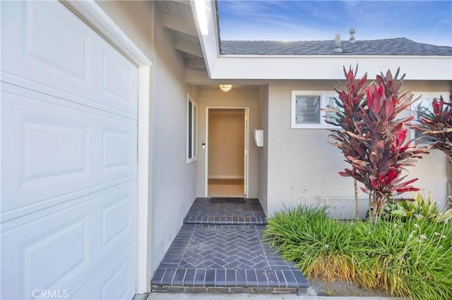12111 Reagan St, Los Alamitos, CA 90720 - view of exterior entry featuring stucco siding and a shingled roof