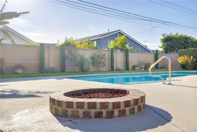 12111 Reagan St, Los Alamitos, CA 90720 - view of swimming pool featuring a fenced backyard, a fire pit, and a patio area