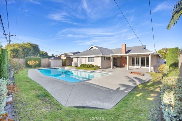 12111 Reagan St, Los Alamitos, CA 90720 - view of pool featuring a patio, a fenced backyard, and a storage shed