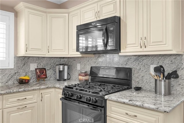 12111 Reagan St, Los Alamitos, CA 90720 - kitchen with black appliances, cream cabinetry, and backsplash
