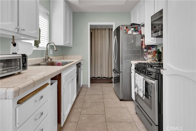 139 Flag Way Unit C, Paso Robles, CA 93446 - kitchen with stainless steel appliances, tile countertops, white cabinetry, and light tile patterned floors