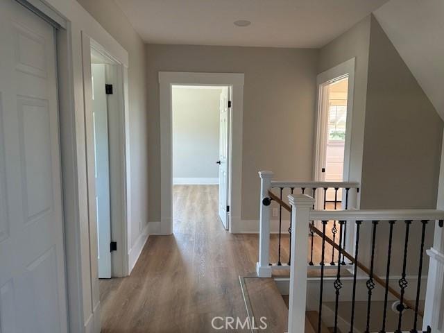 1902 E Citrus Ave, Redlands, CA 92374 - corridor with an upstairs landing and wood finished floors
