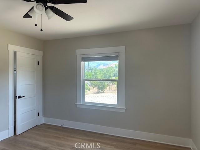 1902 E Citrus Ave, Redlands, CA 92374 - unfurnished room with wood finished floors and a ceiling fan