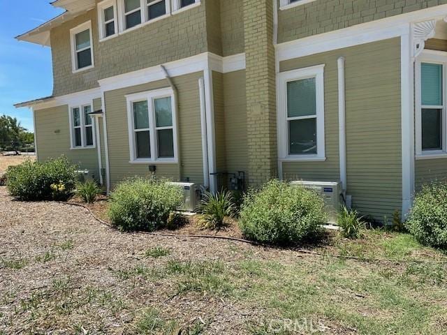 1902 E Citrus Ave, Redlands, CA 92374 - view of side of home featuring brick siding and a cooling unit
