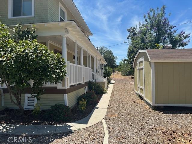 1902 E Citrus Ave, Redlands, CA 92374 - view of home's exterior with covered porch and a storage unit