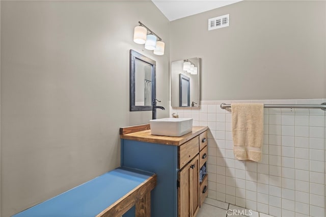 932 Redwood Ct, Corona, CA 92879 - bathroom featuring vanity, tile walls, and wainscoting