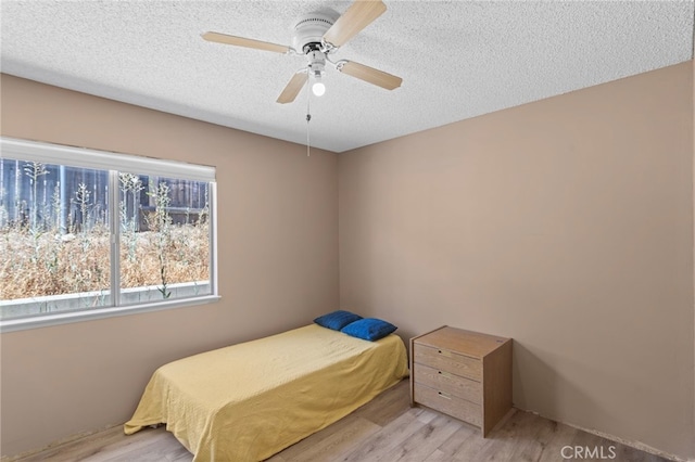 932 Redwood Ct, Corona, CA 92879 - bedroom with light wood-style flooring, a textured ceiling, and ceiling fan