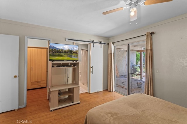 932 Redwood Ct, Corona, CA 92879 - bedroom featuring access to outside, wood finished floors, a barn door, and a ceiling fan