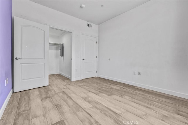 991 Arapahoe St Unit 202A, Los Angeles, CA 90006 - unfurnished bedroom with light wood-type flooring, electric panel, and a closet