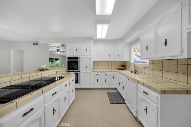 10802 Jordan Rd, Whittier, CA 90603 - kitchen with stainless steel double oven, dishwasher, tile countertops, decorative backsplash, and ceiling fan