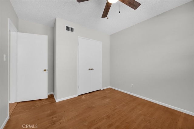 10802 Jordan Rd, Whittier, CA 90603 - unfurnished bedroom with wood finished floors, a textured ceiling, a ceiling fan, and a closet