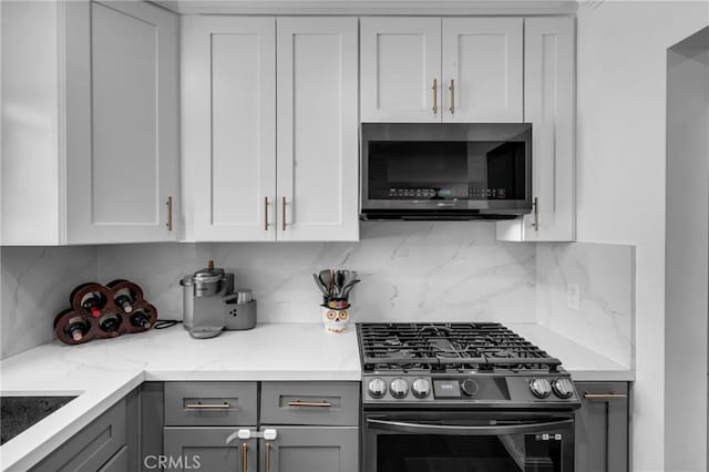 7503 Norwalk Blvd, Whittier, CA 90606 - kitchen featuring stainless steel appliances, gray cabinetry, backsplash, white cabinets, and light stone countertops