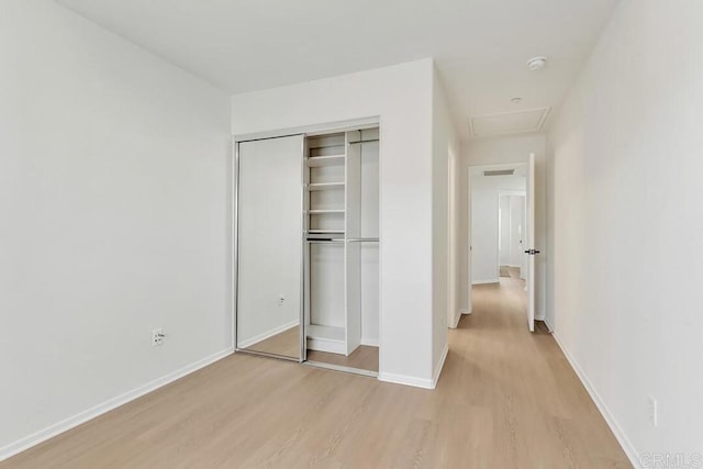 1131 Elfin Forest Rd E, San Marcos, CA 92078 - unfurnished bedroom featuring light wood-style flooring and a closet