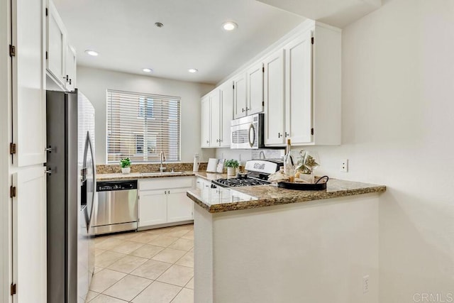 1131 Elfin Forest Rd E, San Marcos, CA 92078 - kitchen featuring stainless steel appliances, a peninsula, white cabinetry, light tile patterned floors, and light stone counters