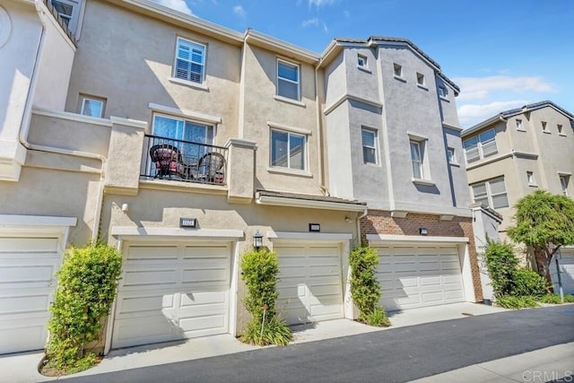 1131 Elfin Forest Rd E, San Marcos, CA 92078 - view of front facade featuring a garage, stucco siding, and a balcony