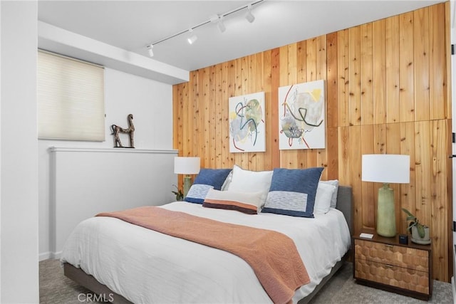 769 Greystone Pl, San Luis Obispo, CA 93401 - bedroom with rail lighting, carpet floors, and wood walls