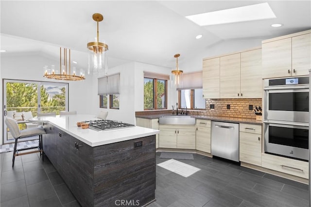 769 Greystone Pl, San Luis Obispo, CA 93401 - kitchen featuring appliances with stainless steel finishes, lofted ceiling, backsplash, a skylight, and a chandelier