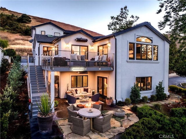 769 Greystone Pl, San Luis Obispo, CA 93401 - back of property featuring an outdoor living space with a fire pit, a balcony, and stucco siding