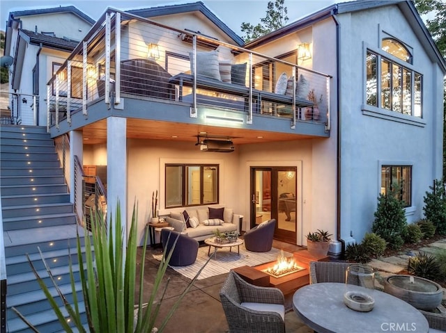 769 Greystone Pl, San Luis Obispo, CA 93401 - rear view of property featuring stairs, a balcony, stucco siding, and an outdoor living space with a fire pit