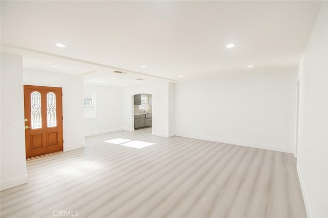 13132 Stanrich Pl, Garden Grove, CA 92843 - unfurnished living room with arched walkways, light wood-style floors, and recessed lighting