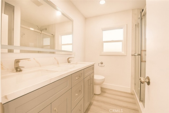 13132 Stanrich Pl, Garden Grove, CA 92843 - bathroom with wood finished floors, plenty of natural light, double vanity, an enclosed shower, and recessed lighting