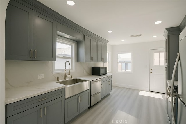 13132 Stanrich Pl, Garden Grove, CA 92843 - kitchen with black microwave, dishwashing machine, light wood finished floors, plenty of natural light, and recessed lighting
